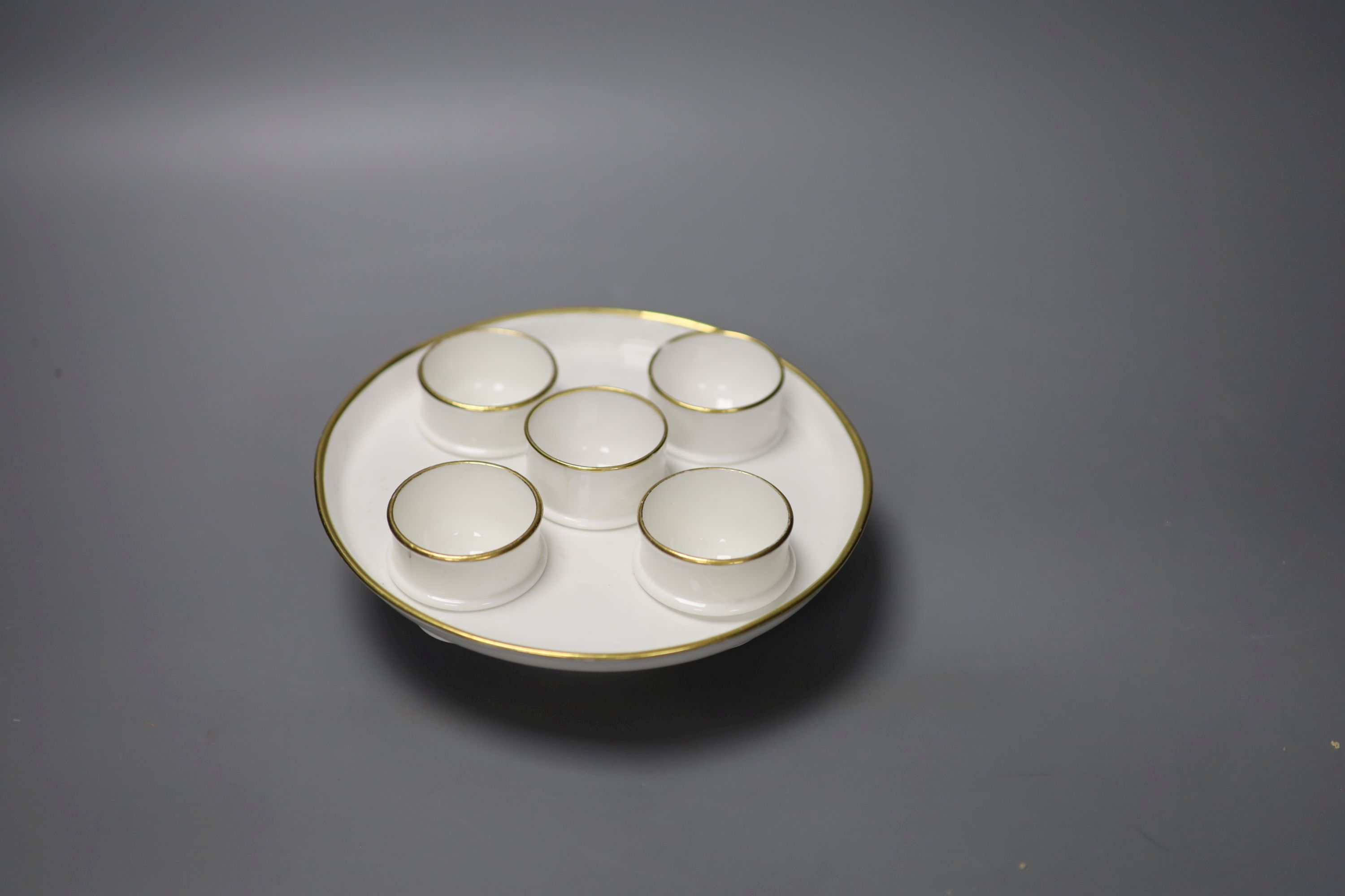 A Spode rare egg cruet having five matching egg cups, c.1805, Spode in red to base, diameter 18cm